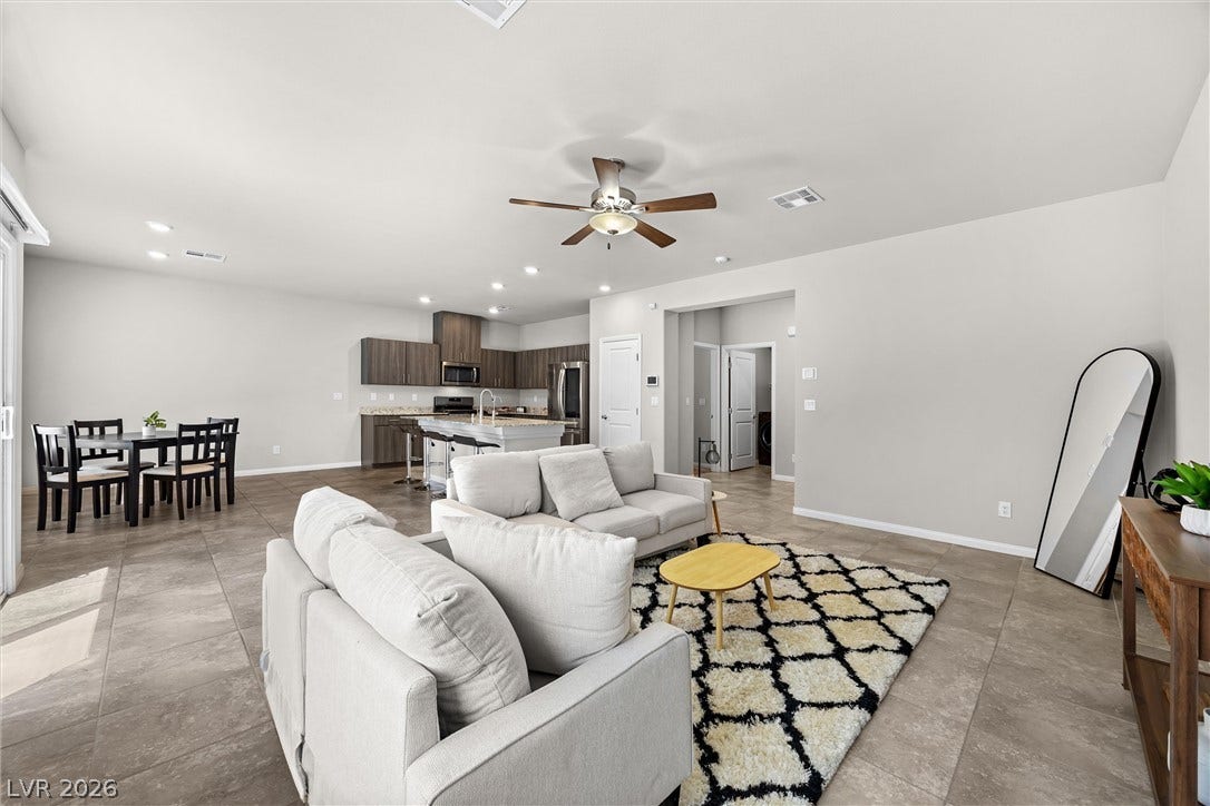 8943 Pelican Point Street, Las Vegas, NV 89178 An open concept living and dining area adjoins a modern kitchen, creating an ideal space for entertaining.