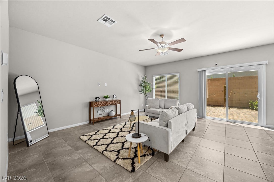 8943 Pelican Point Street, Las Vegas, NV 89178 A well-lit gathering space with easy outdoor access, perfect for relaxation and entertaining.