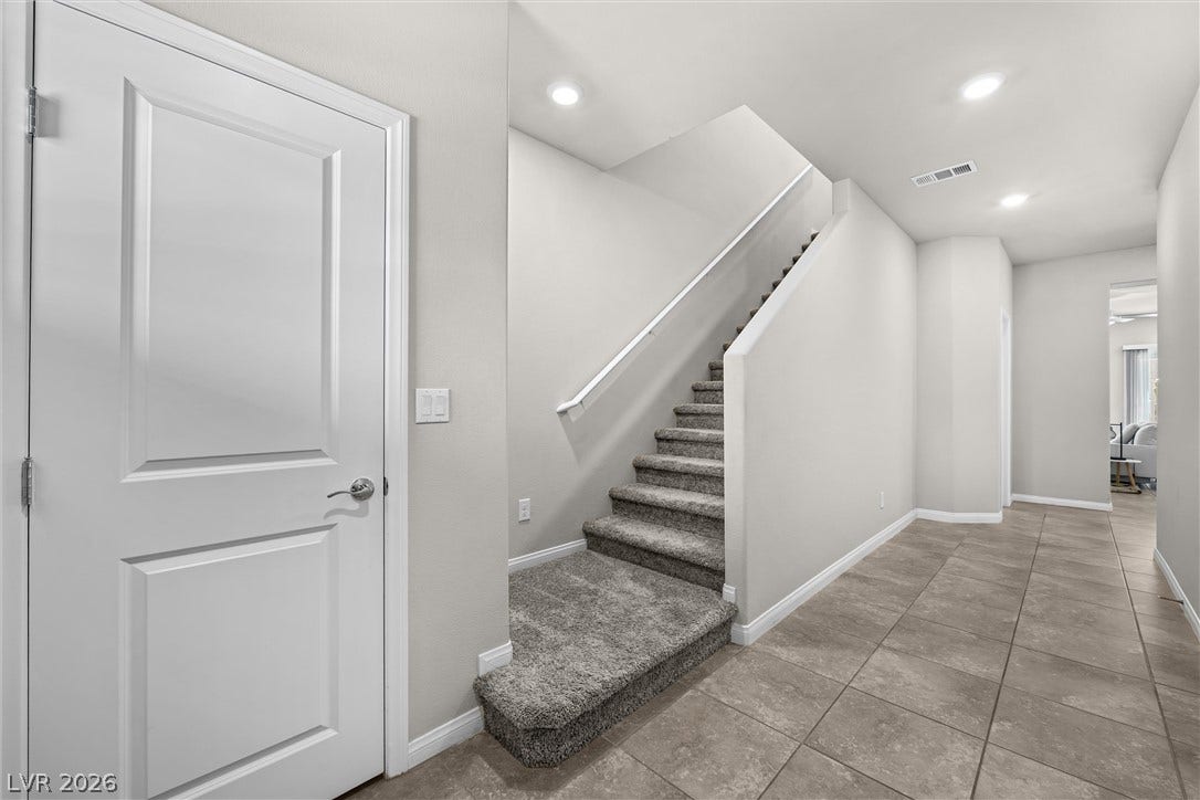 8943 Pelican Point Street, Las Vegas, NV 89178 A welcoming entryway features tile flooring and convenient staircase access to upper levels.