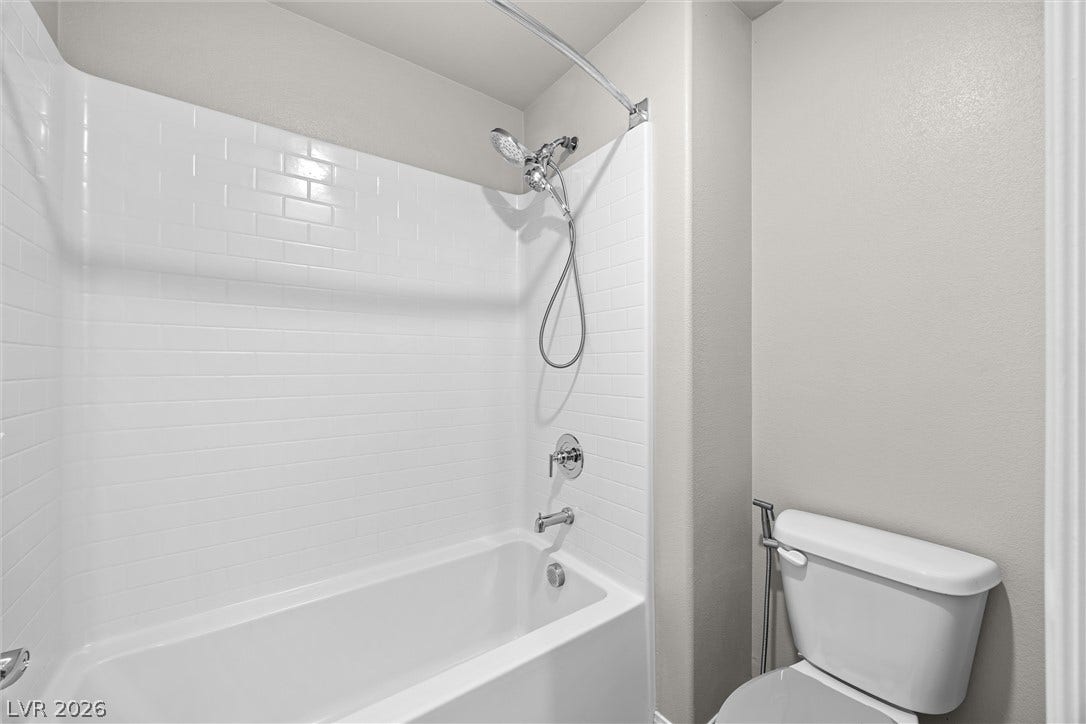 8943 Pelican Point Street, Las Vegas, NV 89178 A pristine bathroom featuring a classic bathtub with subway tile surround and modern fixtures.