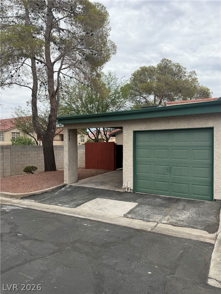 A convenient attached carport and garage provide ample parking and storage options.