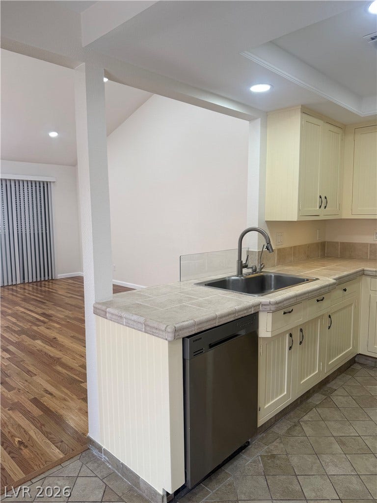 A well-appointed kitchen featuring a stainless steel dishwasher and ample counter space.