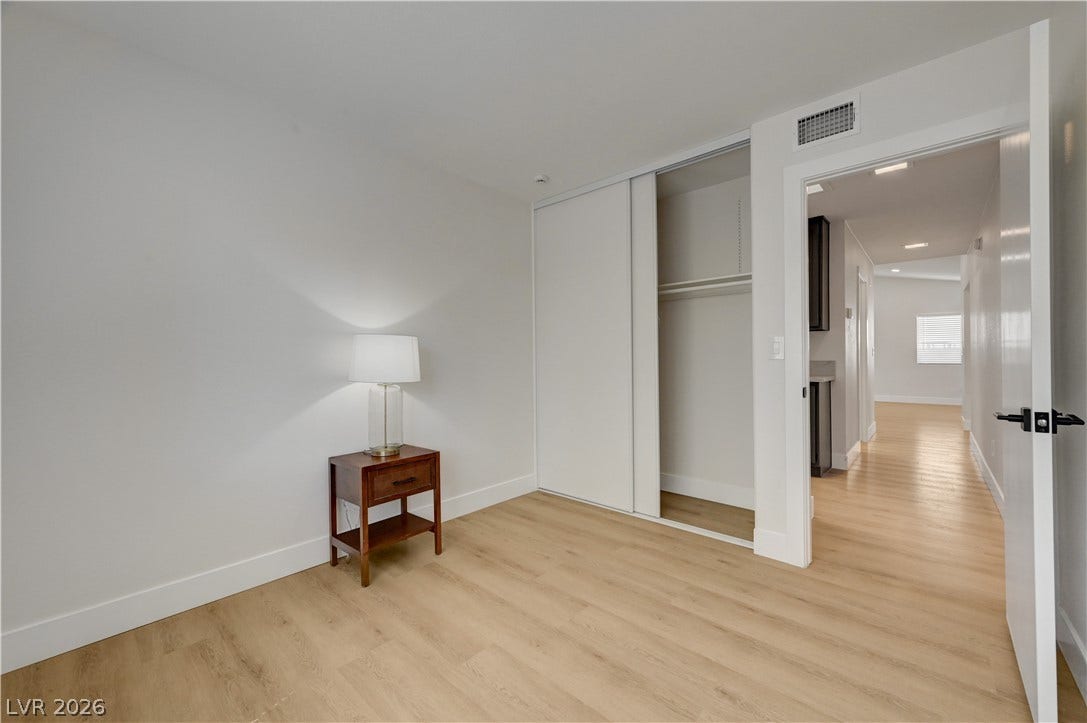 3131 White Rose Way, Henderson, NV 89014 A well-lit bedroom with ample closet space and durable vinyl plank flooring throughout.
