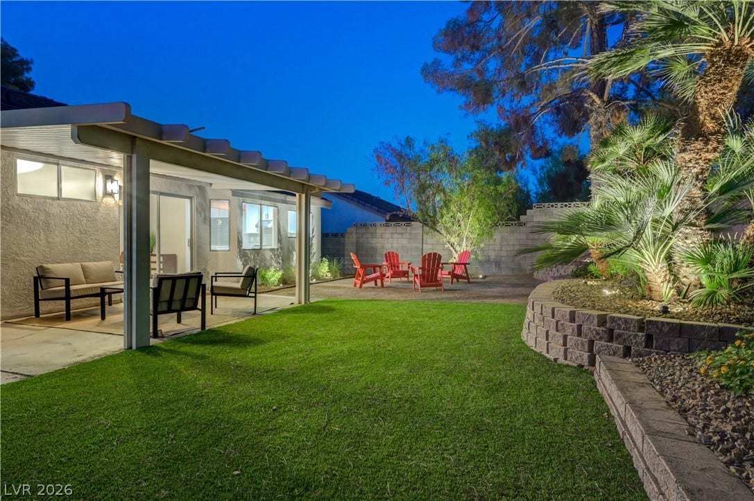 3131 White Rose Way, Henderson, NV 89014 A private outdoor space with a covered patio, verdant lawn, and mature landscaping offers an ideal setting for gatherings.