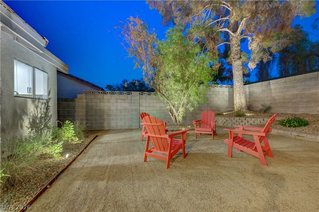 3131 White Rose Way, Henderson, NV 89014 An inviting backyard retreat features mature trees and ample space for gatherings.