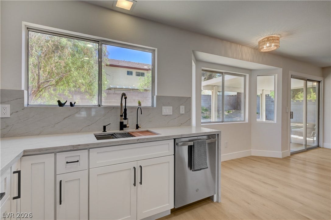 3131 White Rose Way, Henderson, NV 89014 A streamlined kitchen presents ample counter space, bright cabinetry, and a modern sink.