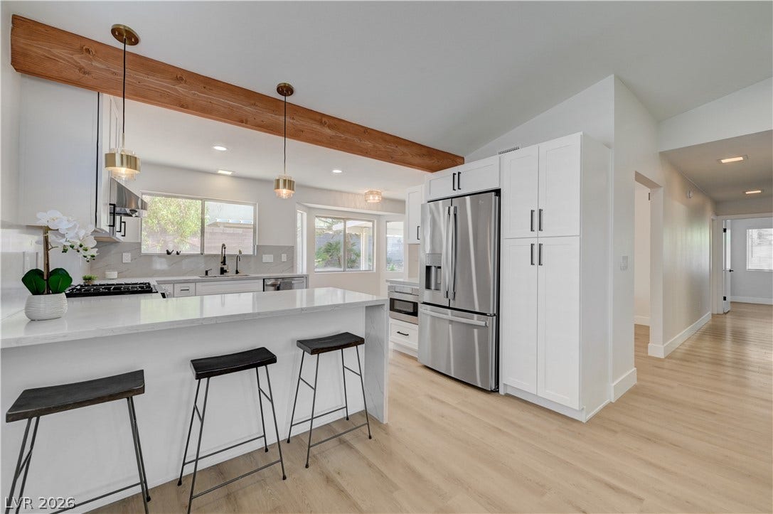 3131 White Rose Way, Henderson, NV 89014 A well-appointed kitchen features a central island, ample cabinet space, and sleek stainless steel appliances.