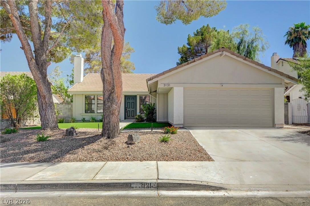 3131 White Rose Way, Henderson, NV 89014 A welcoming facade showcases mature trees and a manicured landscape, creating appealing curb appeal.