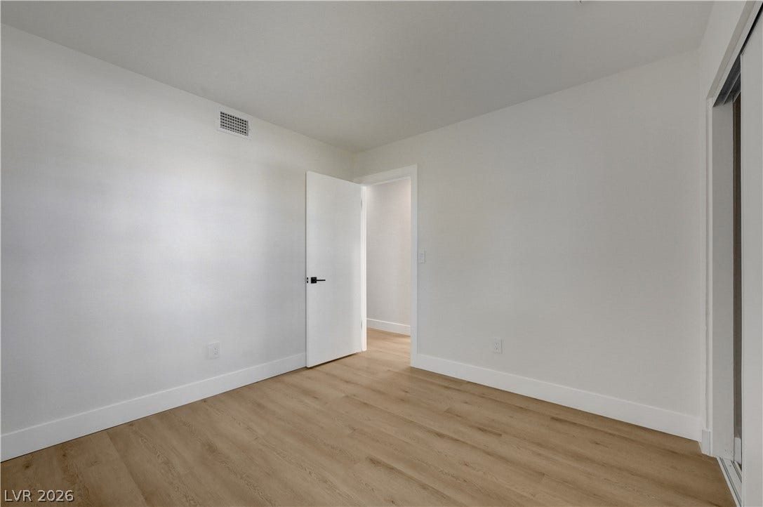 3131 White Rose Way, Henderson, NV 89014 Blonde hardwood flooring and crisp white walls create an airy, neutral foundation.