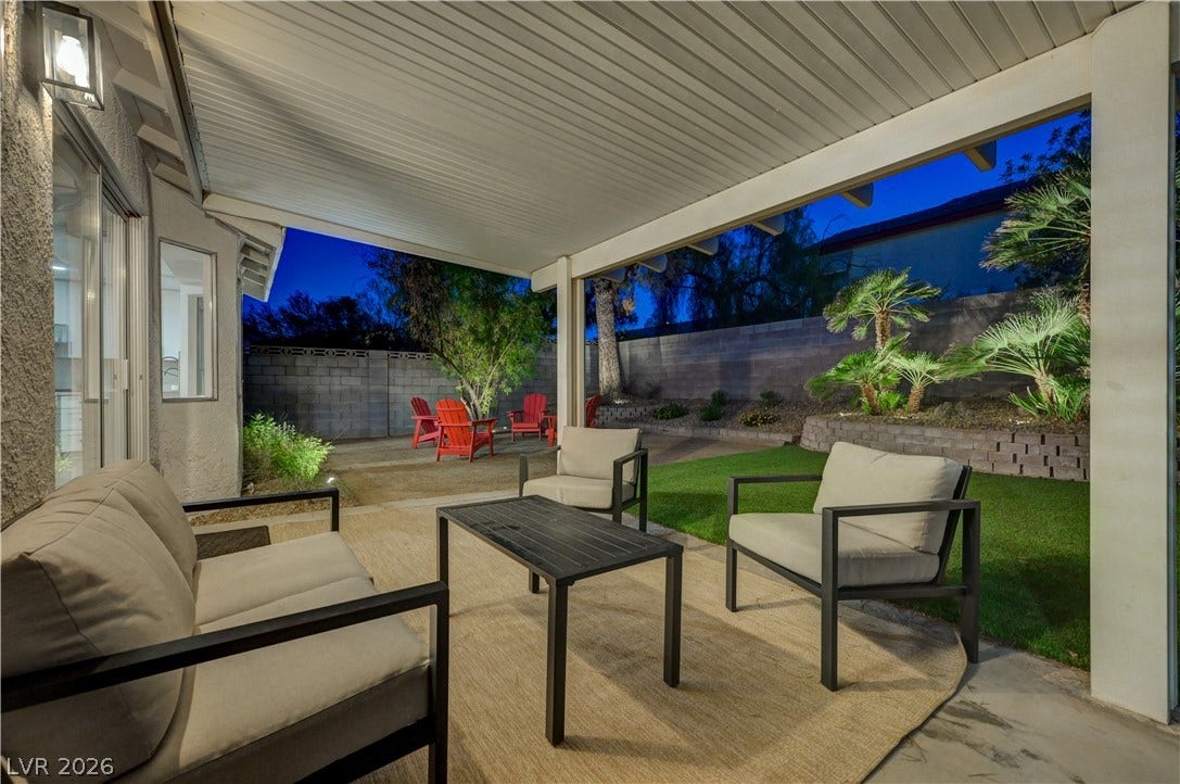 3131 White Rose Way, Henderson, NV 89014 An inviting covered patio offers a private outdoor retreat with a spacious lawn.