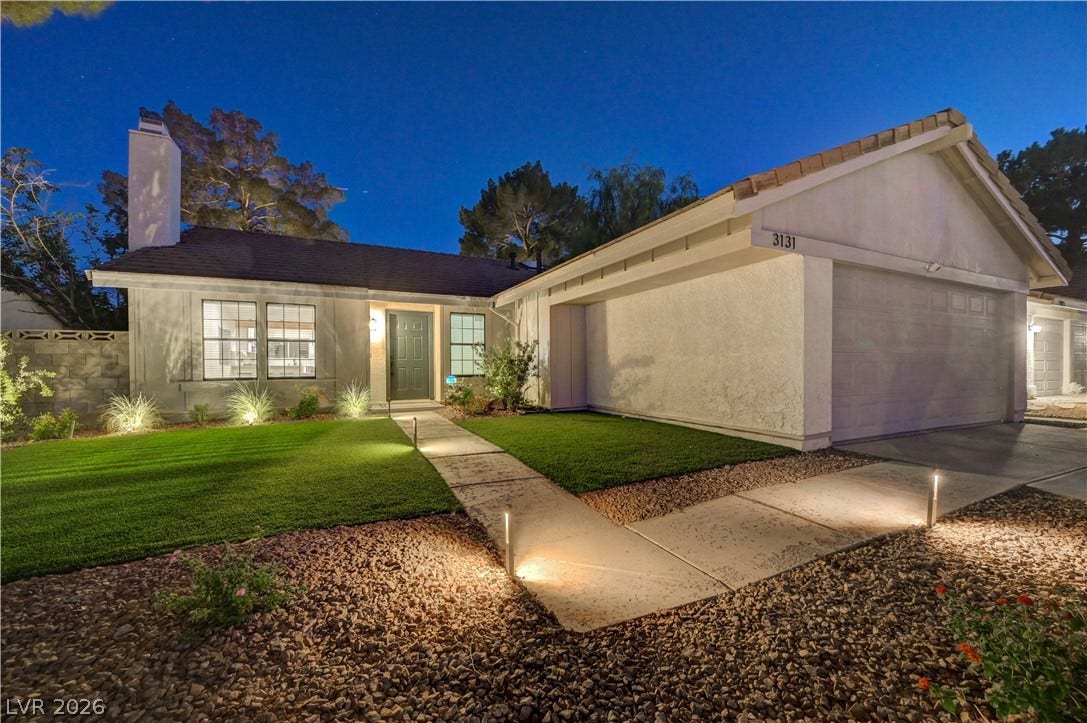 3131 White Rose Way, Henderson, NV 89014 Illuminated walkway leads to a welcoming entry and well-maintained front lawn.