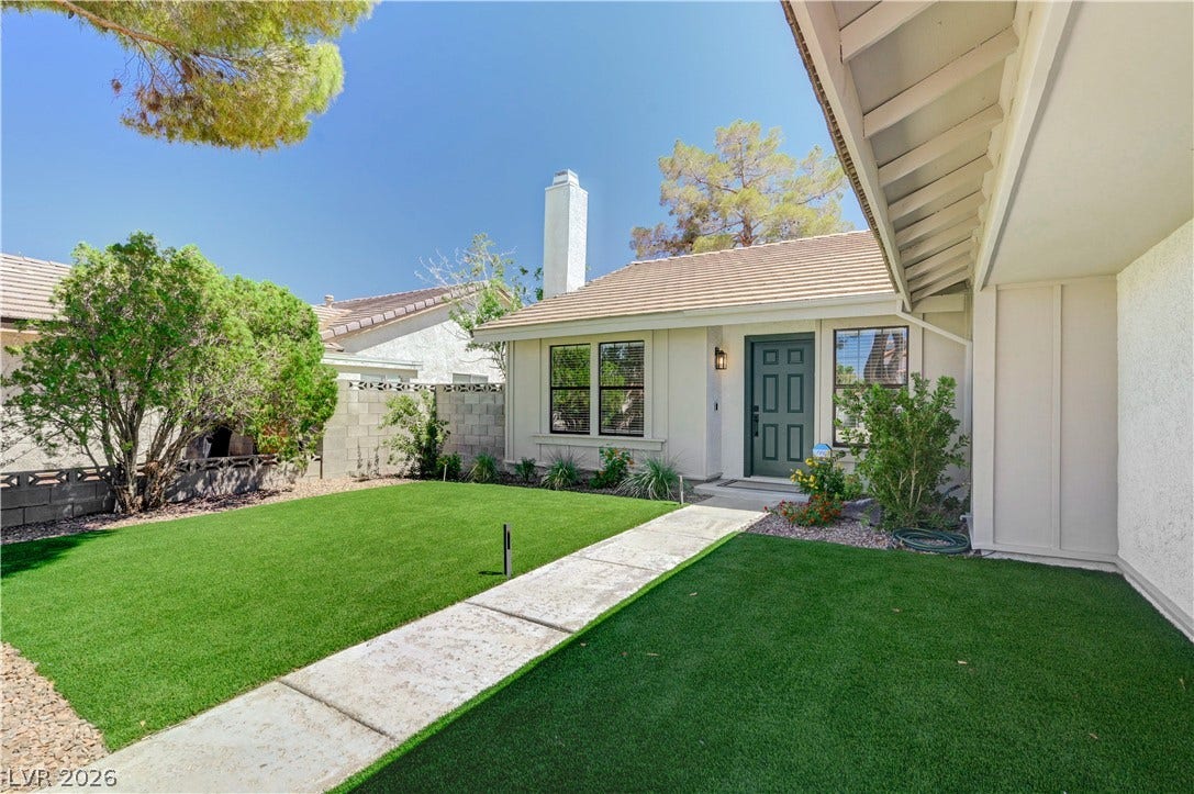 3131 White Rose Way, Henderson, NV 89014 A neatly maintained front yard offers a welcoming approach to this residence with its clean landscaping.