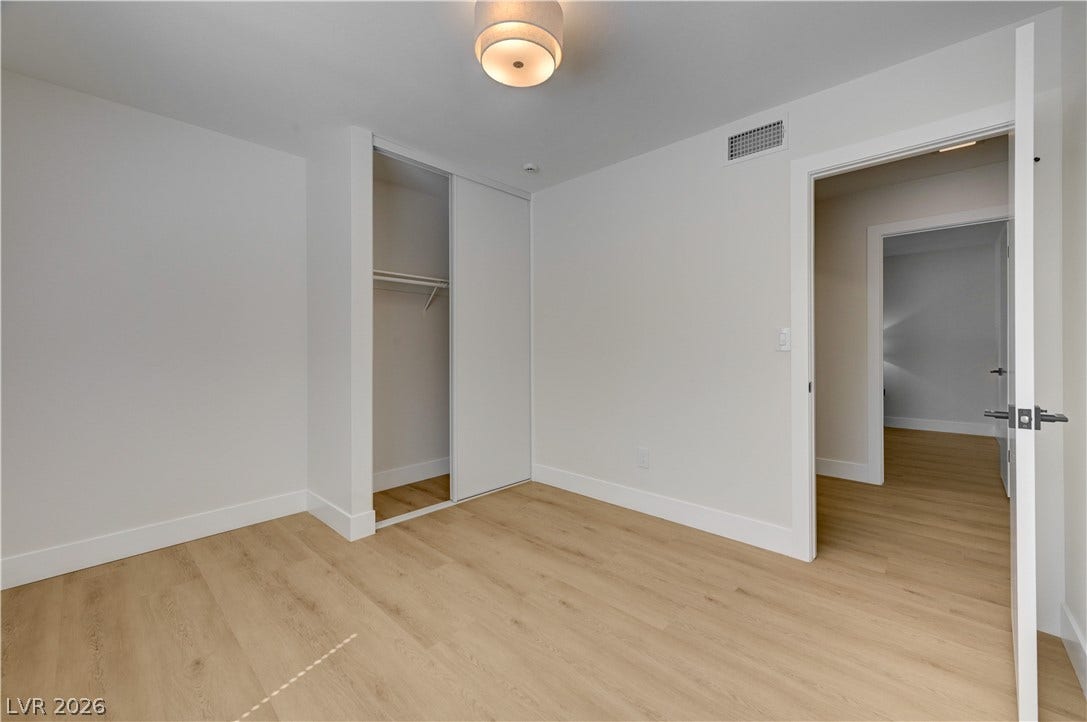 3131 White Rose Way, Henderson, NV 89014 A well-lit bedroom with modern flooring and integrated closet space awaits personalization.