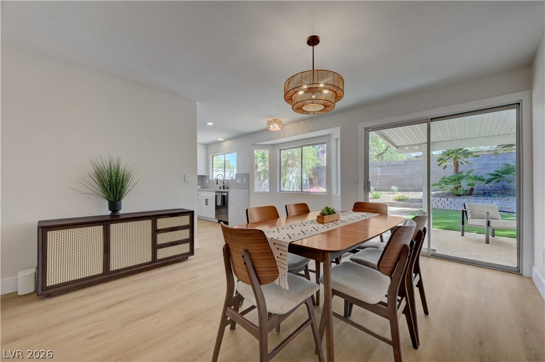 3131 White Rose Way, Henderson, NV 89014 A well-lit dining area offers a seamless connection to the outdoor living space.