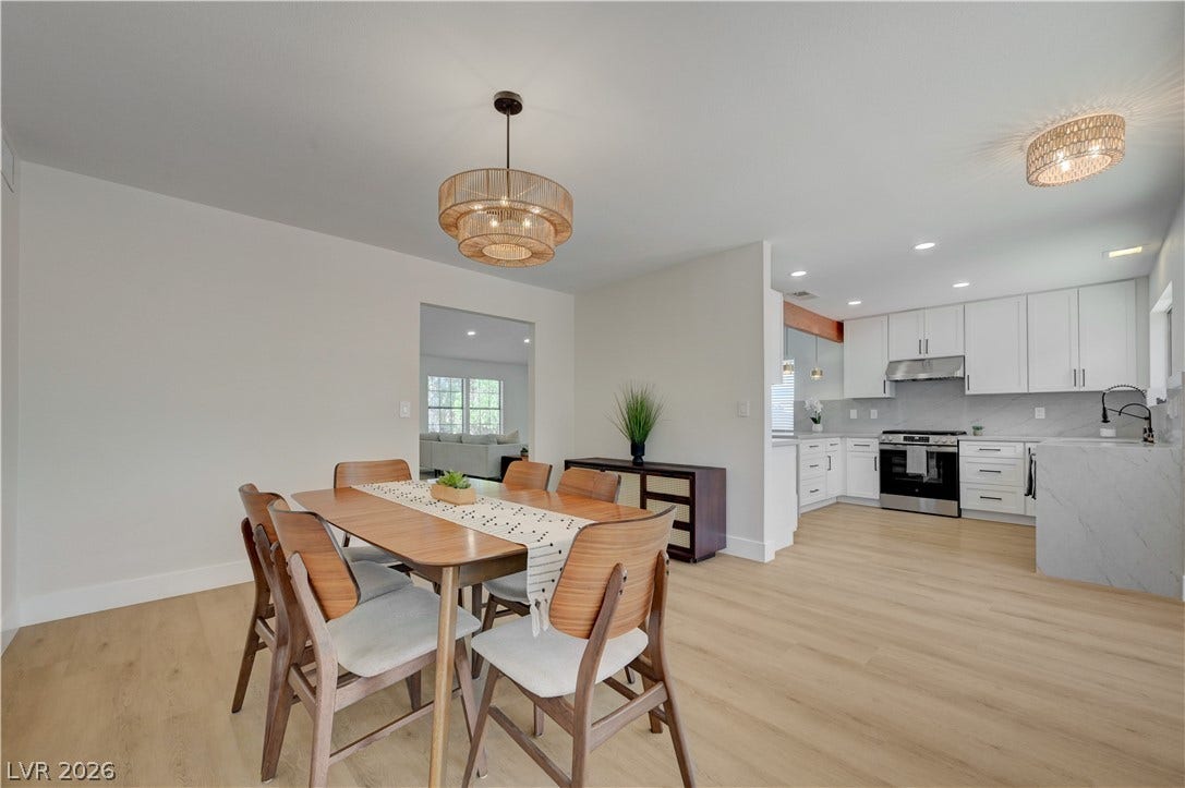3131 White Rose Way, Henderson, NV 89014 An open floorplan seamlessly connects the dining area with a modern, well-equipped kitchen.