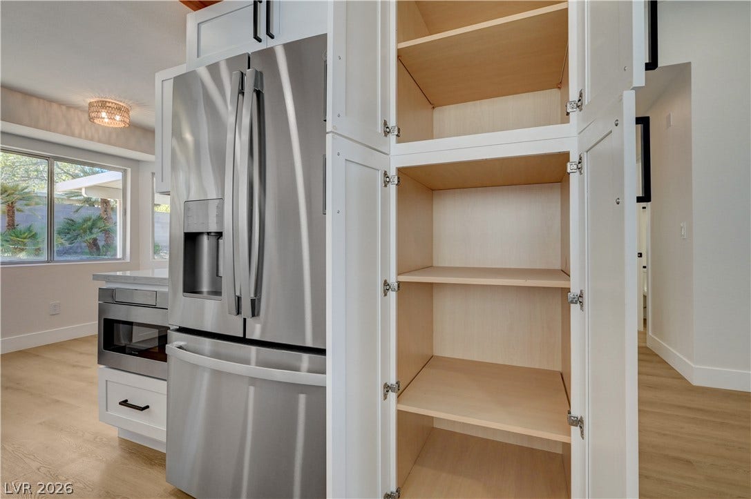3131 White Rose Way, Henderson, NV 89014 A well-equipped kitchen featuring stainless steel appliances and abundant cabinetry for storage.