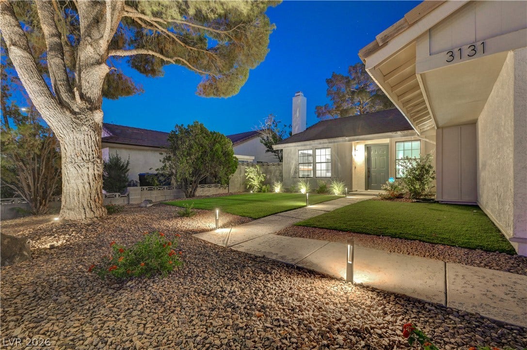 3131 White Rose Way, Henderson, NV 89014 Illuminated pathway and manicured lawn create a welcoming approach to this attractive single-story residence.