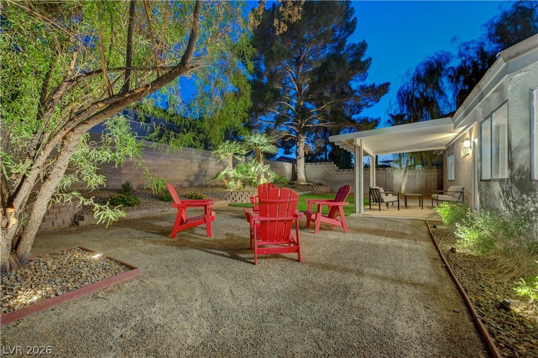 3131 White Rose Way, Henderson, NV 89014 An inviting backyard oasis features a covered patio perfect for evening relaxation.