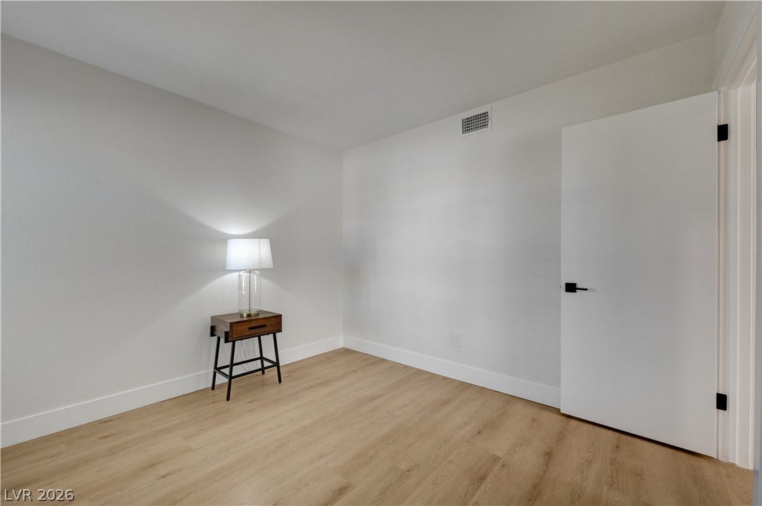 3131 White Rose Way, Henderson, NV 89014 Hardwood-style flooring and fresh white walls create an inviting and versatile interior space.