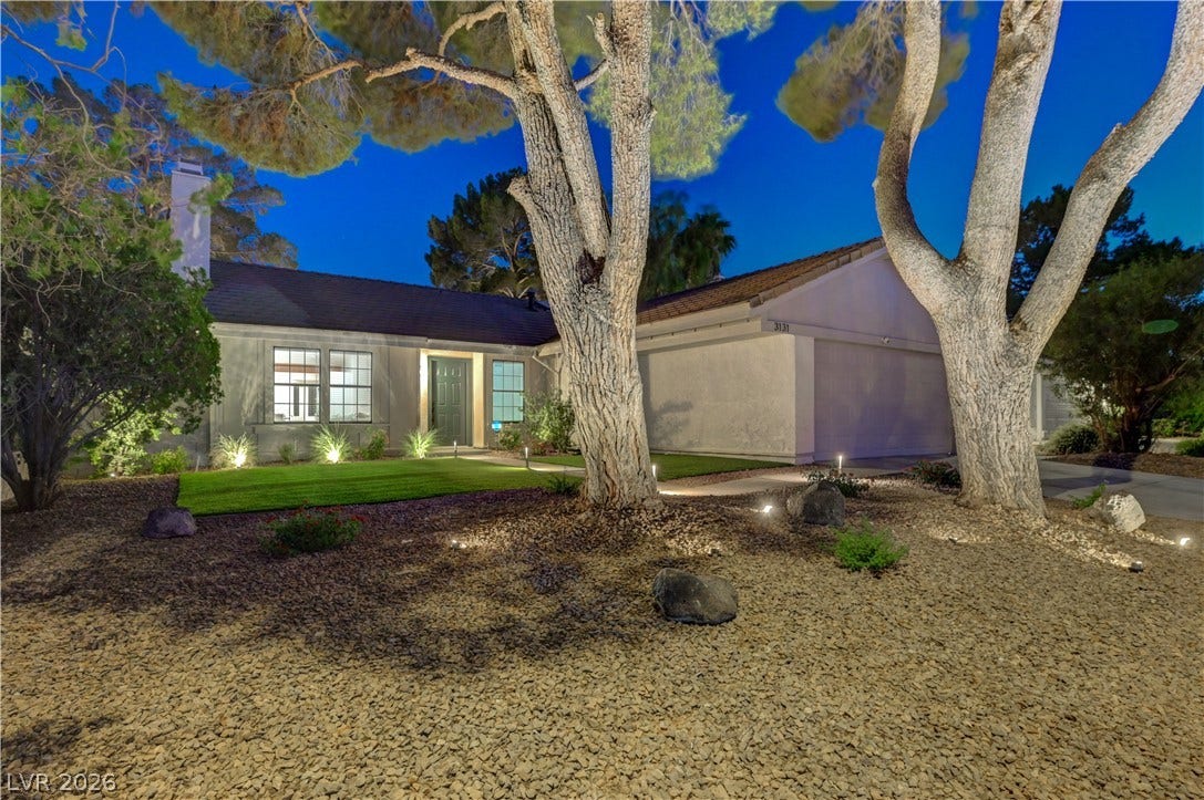 3131 White Rose Way, Henderson, NV 89014 Illuminated by thoughtful landscaping lights, a charming dwelling awaits.
