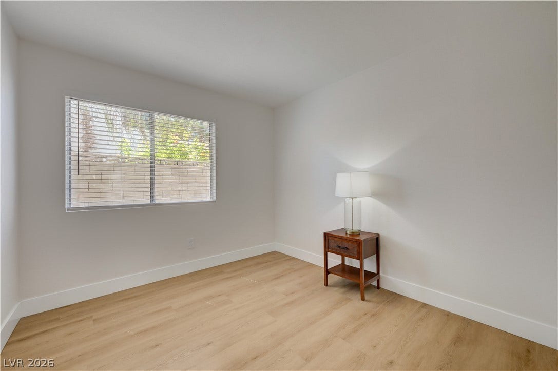 3131 White Rose Way, Henderson, NV 89014 A well-lit room with wood flooring, offering a fresh, versatile space.