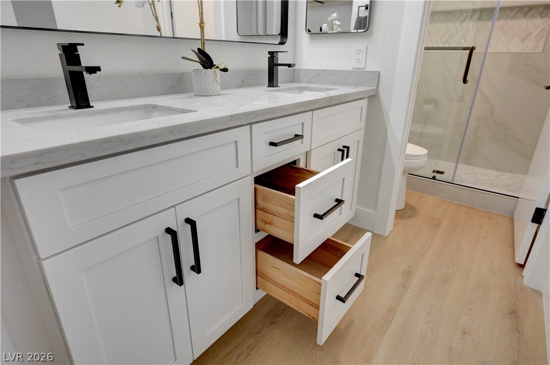3131 White Rose Way, Henderson, NV 89014 Double vanity with contemporary fixtures and ample storage options.