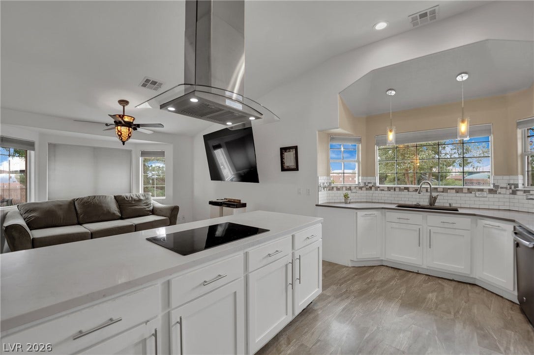 9180 Mohawk Street, Las Vegas, NV 89139 Kitchen with island range hood, decorative backsplash, white cabinets, and black electric cooktop