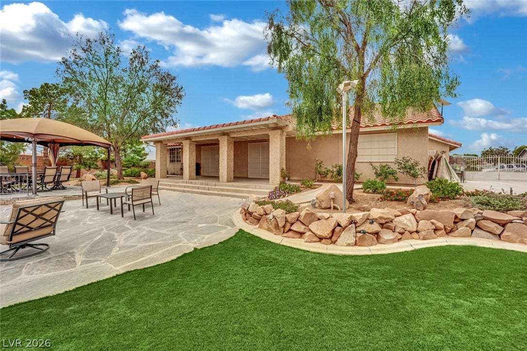 9180 Mohawk Street, Las Vegas, NV 89139 Back of property with stucco siding, a patio area, a tile roof, and outdoor dining space