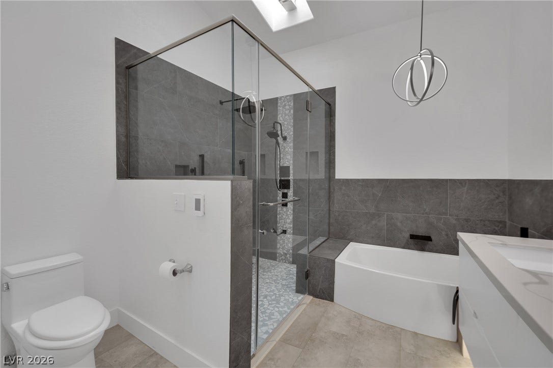 9180 Mohawk Street, Las Vegas, NV 89139 Bathroom with vanity, a shower stall, a garden tub and heated floor