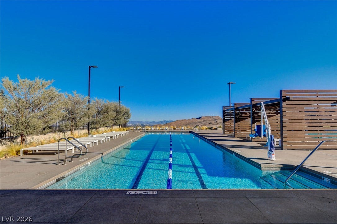 An inviting community pool with lap lanes beckons, offering a refreshing desert oasis.