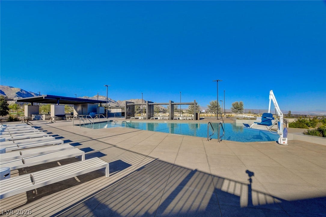 An inviting outdoor community pool with mountain vistas offers recreation and relaxation.
