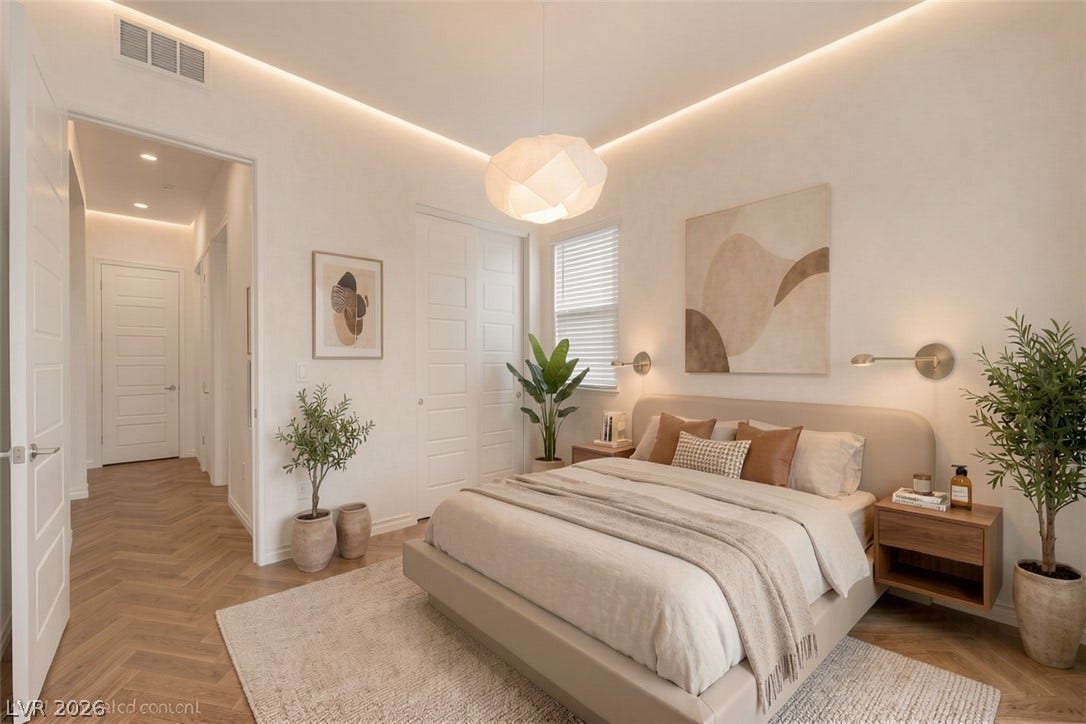 Herringbone hardwood floors add warmth to this serene and inviting primary bedroom.