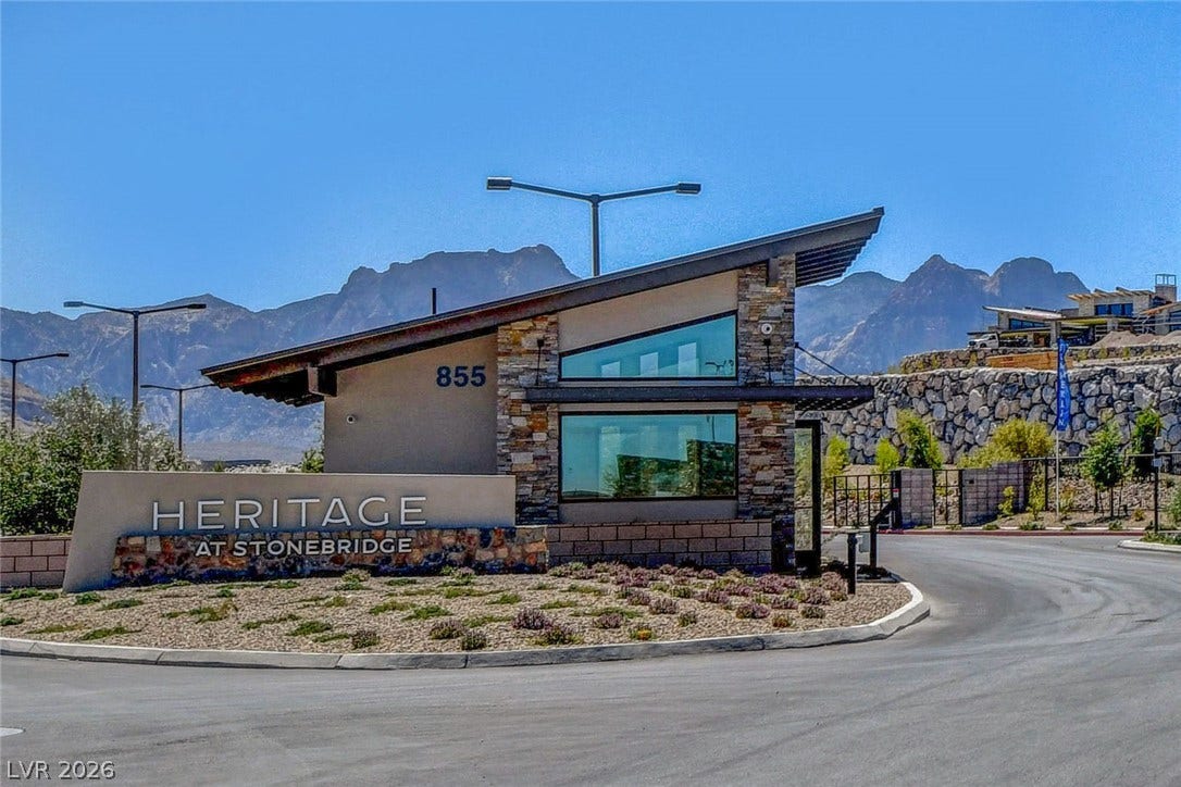 A striking modern stone and stucco entry gatehouse welcomes residents to this desert mountain community.