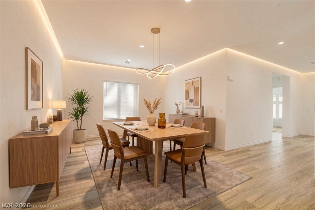 Recessed lighting illuminates this dining area with wide plank wood flooring.