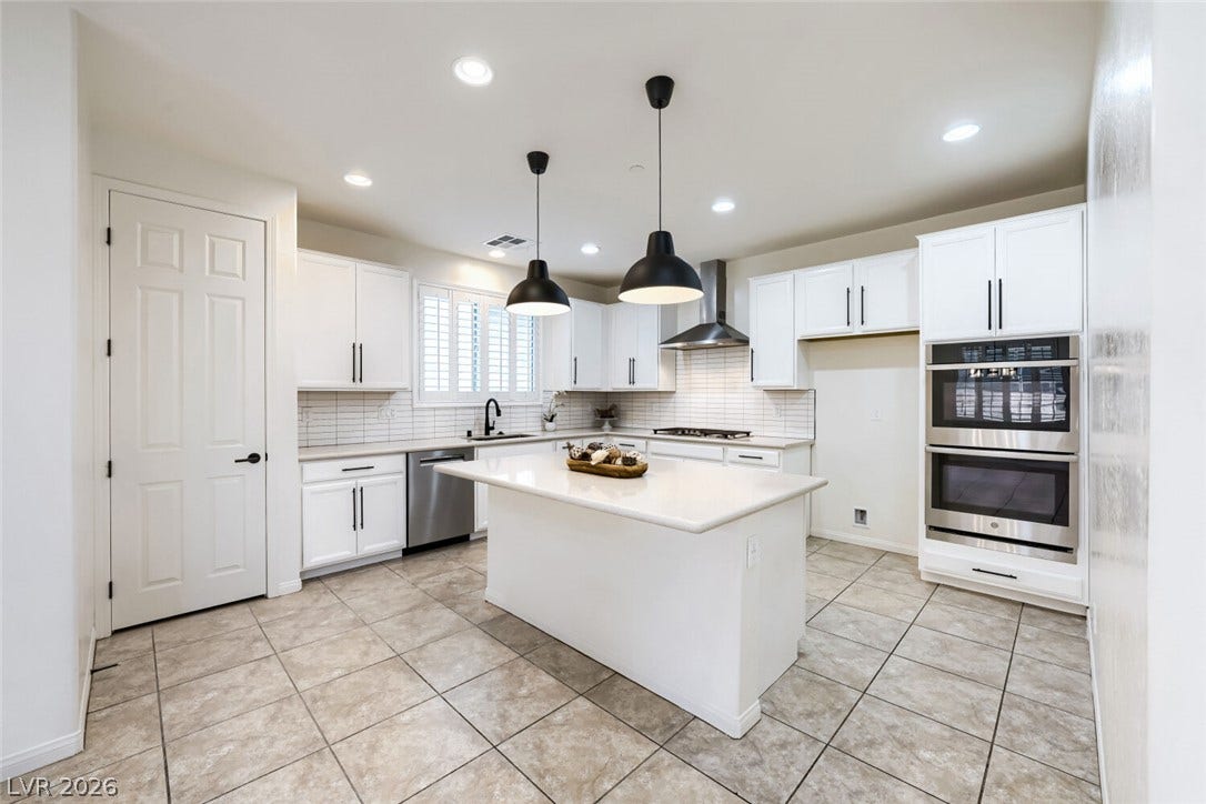 189 Lilt Avenue, Henderson, NV 89011 Central kitchen island provides ample counter space, complemented by recessed lighting and stainless steel appliances.