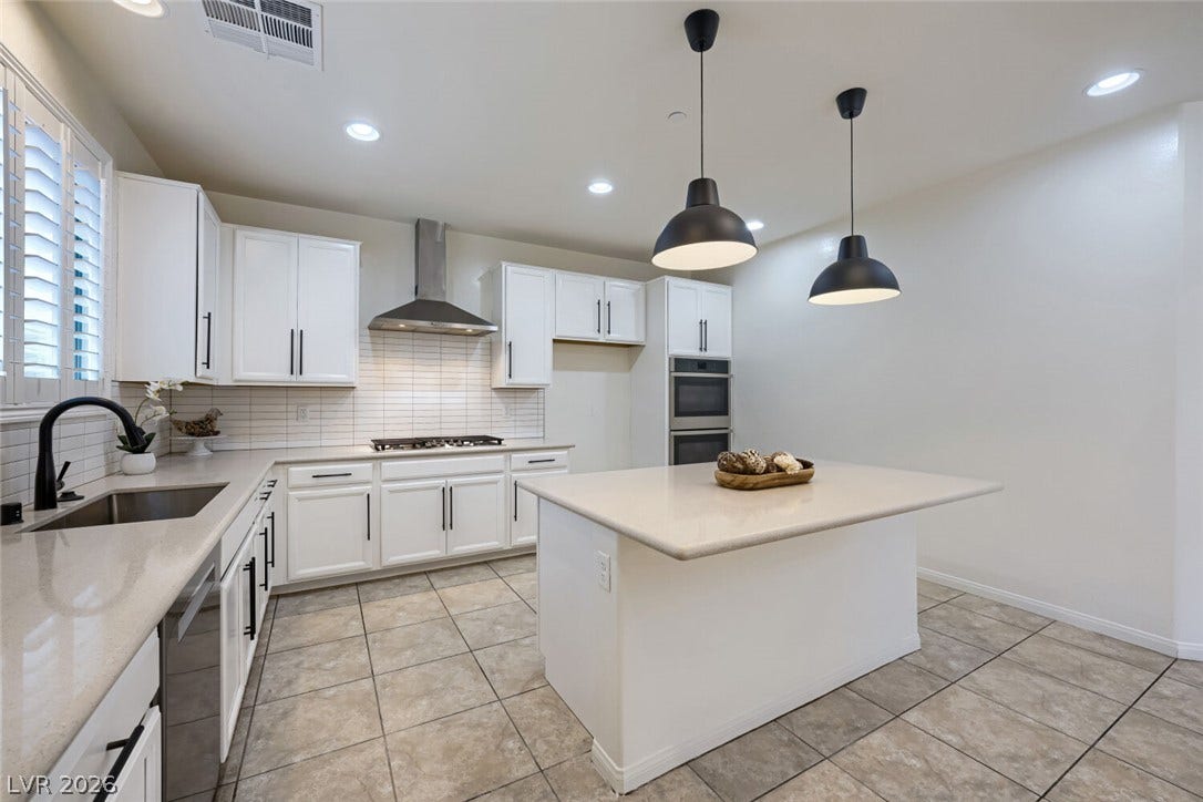 189 Lilt Avenue, Henderson, NV 89011 Culinary adventures await in this kitchen, featuring an island with pendant lighting and built-in appliances.
