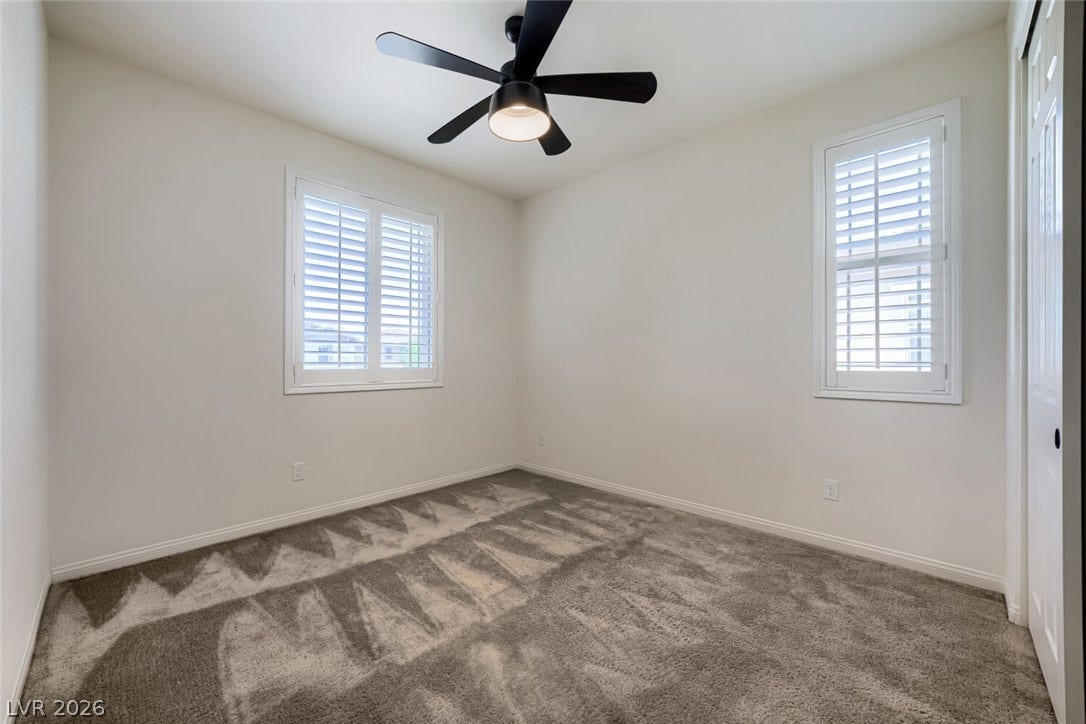 189 Lilt Avenue, Henderson, NV 89011 Well-lit sleeping quarters with a ceiling fan for comfort and privacy shutters on windows.
