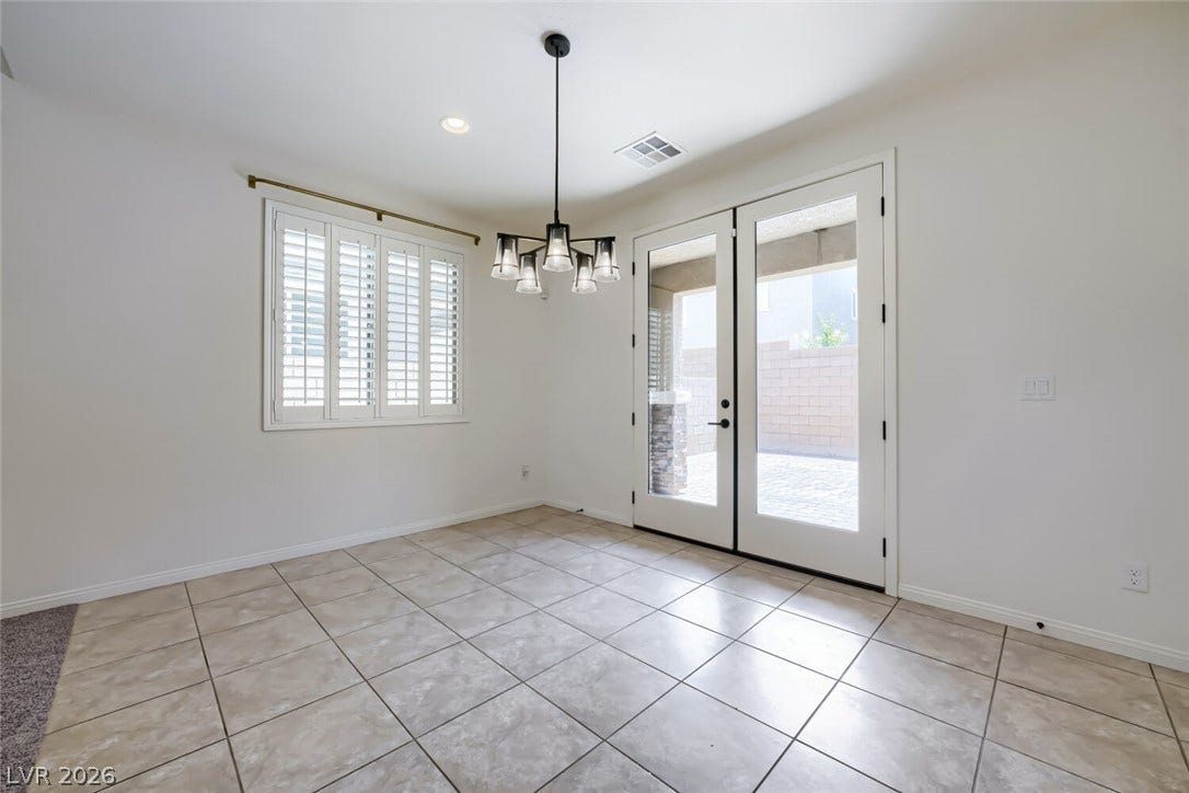189 Lilt Avenue, Henderson, NV 89011 Natural light fills this room, offering a seamless transition to the outdoors through elegant French doors.