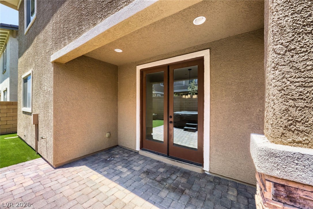 189 Lilt Avenue, Henderson, NV 89011 A private outdoor space with a paved patio extends from French doors, ideal for relaxation.