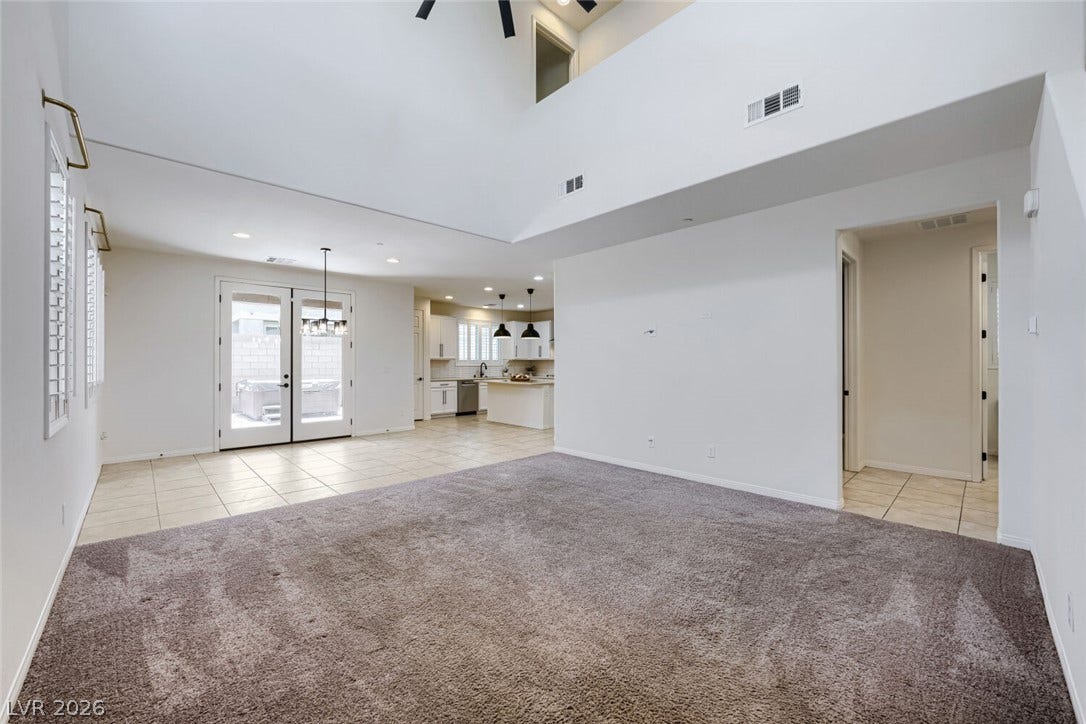 189 Lilt Avenue, Henderson, NV 89011 A spacious living area with soaring ceilings and abundant natural light flows seamlessly to a contemporary kitchen.