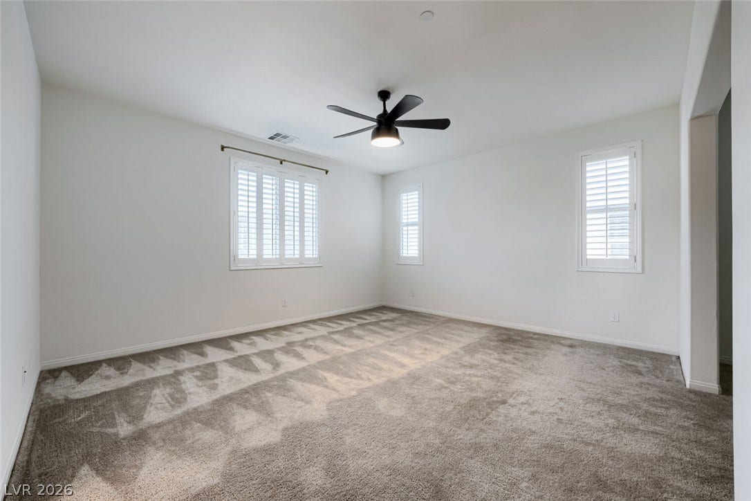 189 Lilt Avenue, Henderson, NV 89011 A spacious room offers comfortable carpeting and natural light through well-appointed window shutters.