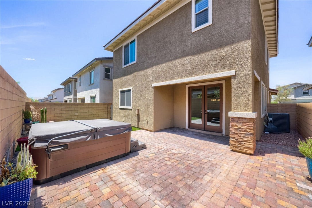 189 Lilt Avenue, Henderson, NV 89011 A private outdoor space with a spa and ample brick paving for relaxation and enjoyment.