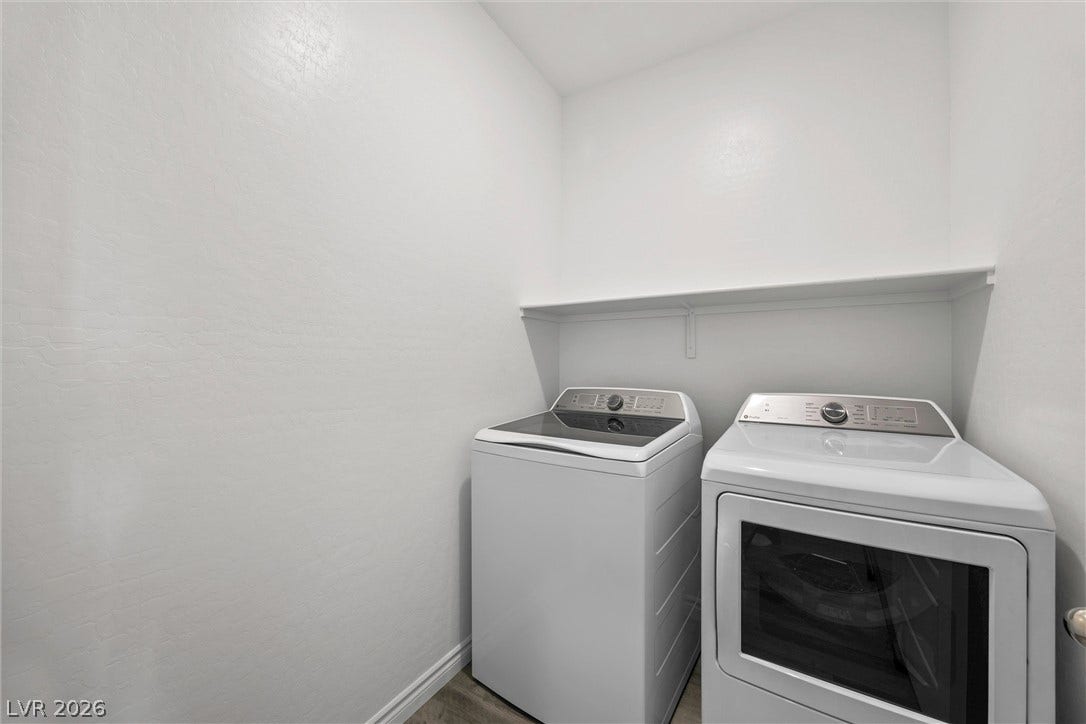 600 N Carriage Hill Drive, #1034, Las Vegas, NV 89138 A dedicated laundry space offers practical convenience with essential appliances and an overhead storage shelf.