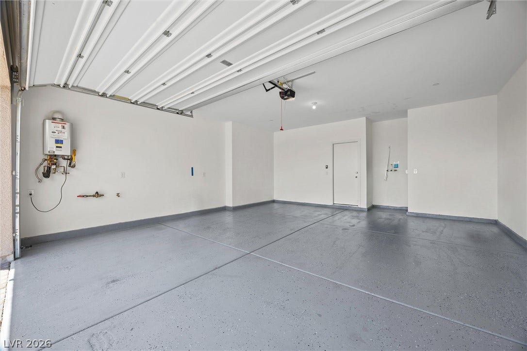 600 N Carriage Hill Drive, #1034, Las Vegas, NV 89138 A spacious garage with a durable epoxy floor and convenient access door.
