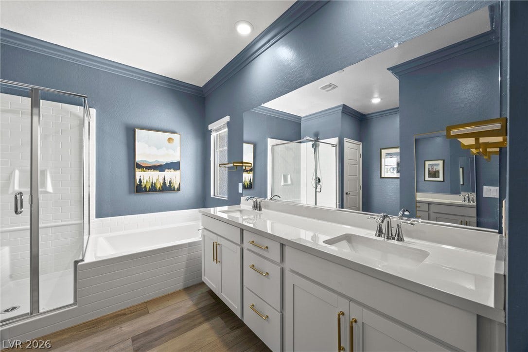 600 N Carriage Hill Drive, #1034, Las Vegas, NV 89138 Dual vanities with modern fixtures complement the spacious shower and deep soaking tub in this well-appointed bathroom.