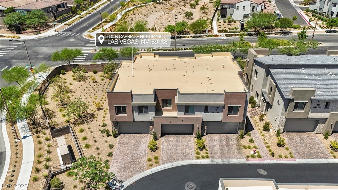 600 N Carriage Hill Drive, #1034, Las Vegas, NV 89138 Perched on a hill, this modern multi-unit residence offers a distinctive architectural style and convenient street access.
