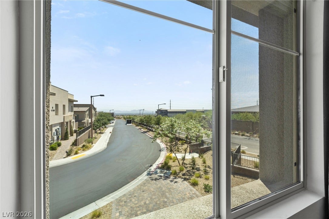 600 N Carriage Hill Drive, #1034, Las Vegas, NV 89138 An elevated perspective offers views of the tranquil neighborhood street and surrounding landscape.