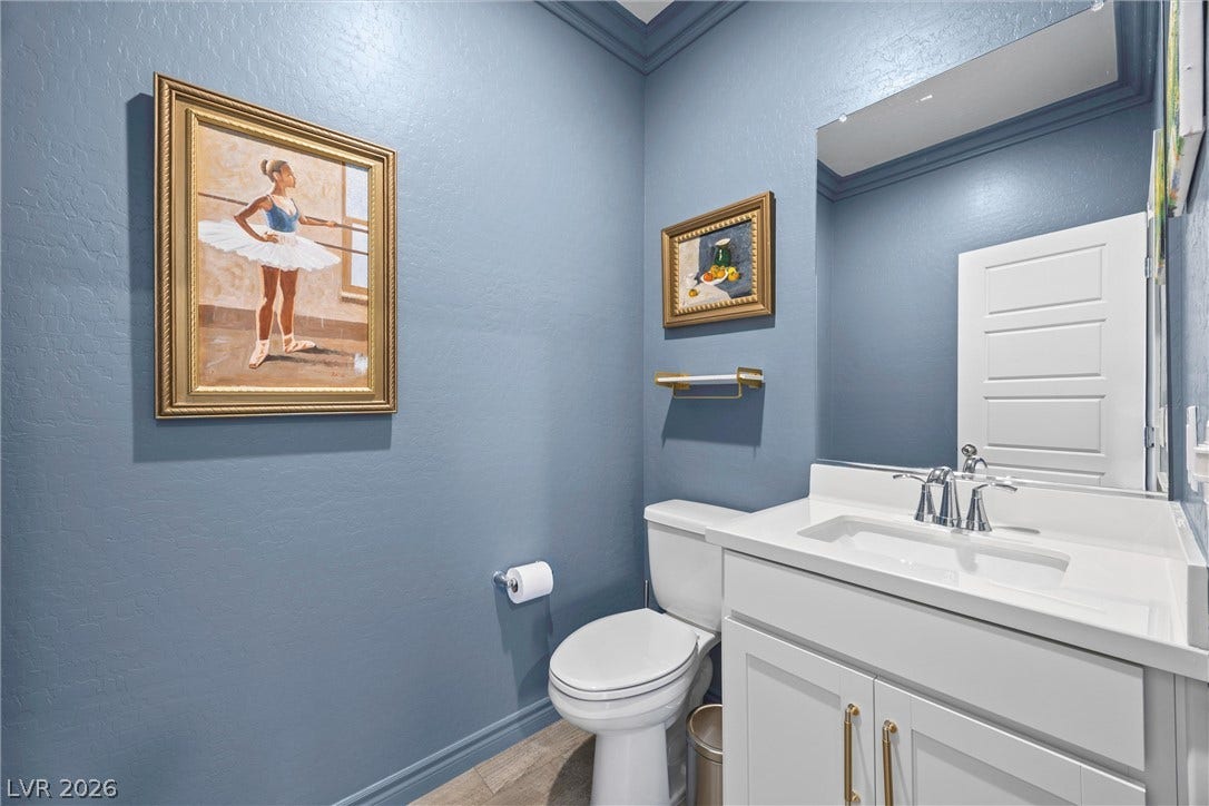 600 N Carriage Hill Drive, #1034, Las Vegas, NV 89138 A compact powder room with a sleek white vanity and a practical commode.