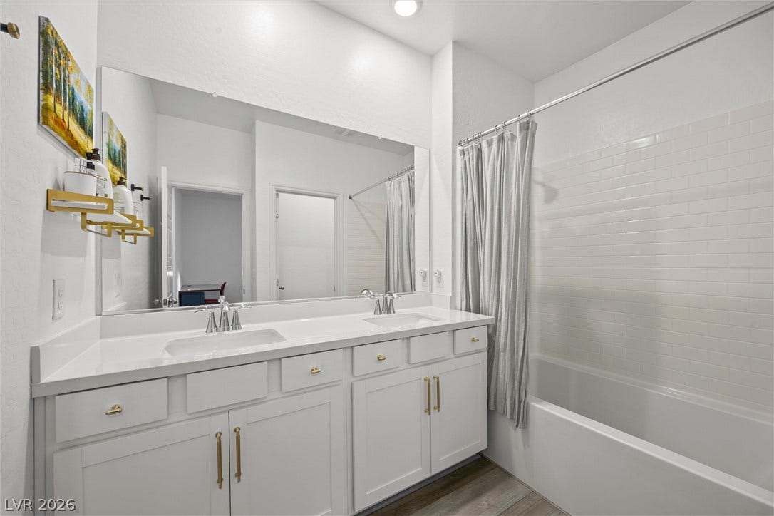 600 N Carriage Hill Drive, #1034, Las Vegas, NV 89138 Double vanity with pristine countertops complements this well-appointed bathroom's clean aesthetic.