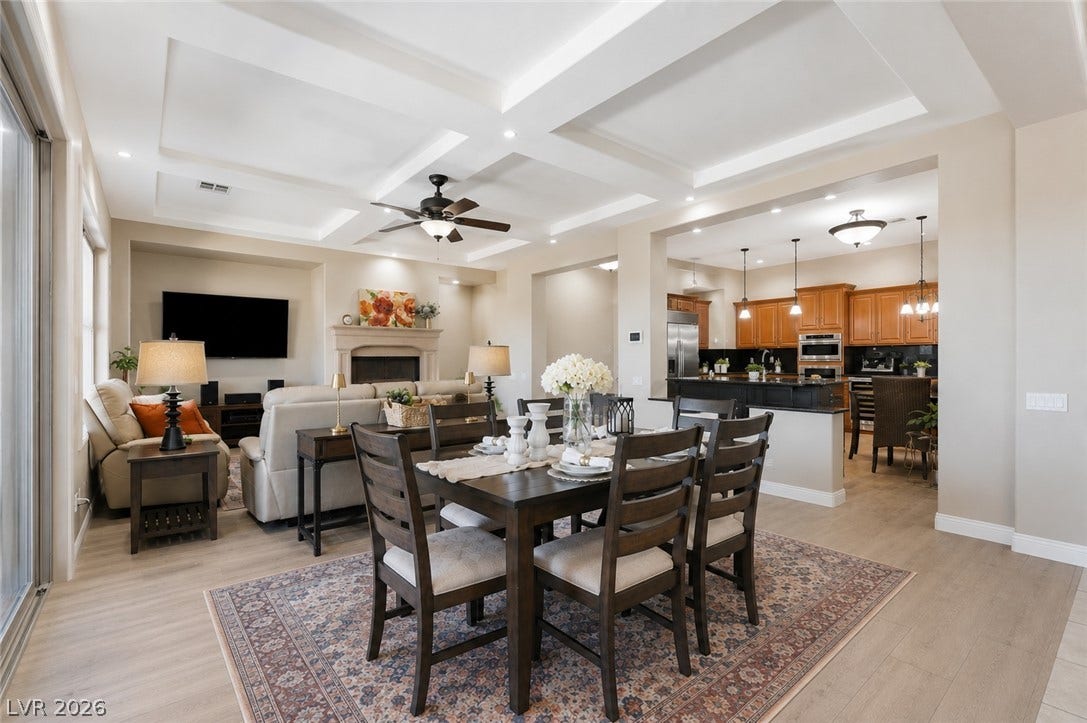 2397 Luberon Drive, Henderson, NV 89044 An open-concept interior features coffered ceilings, recessed lighting, and a charming fireplace.